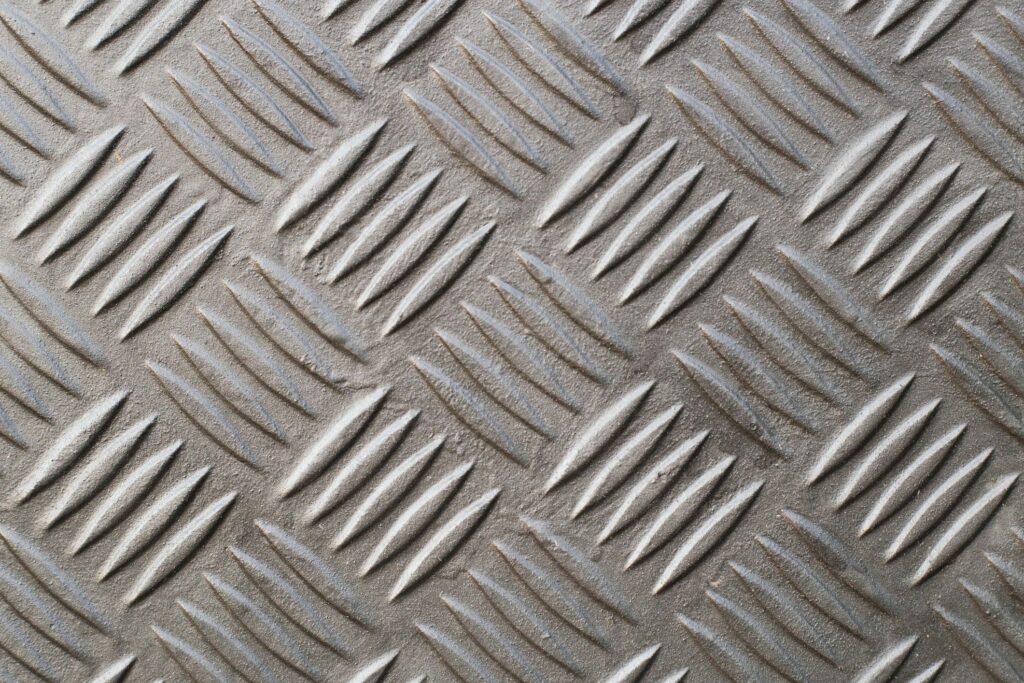 Diamond plate, also known as checker plate, tread plate, cross hatch kick plate and Durbar floor plate, wide shot in landscape orientation.