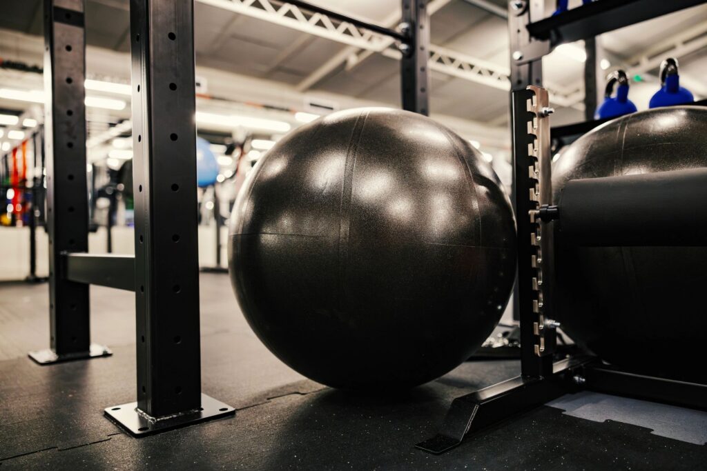 Gym stability ball resting on rubber floor