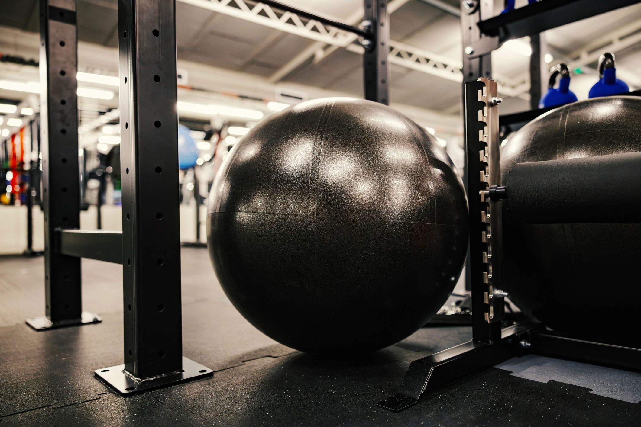 Gym stability ball resting on rubber floor