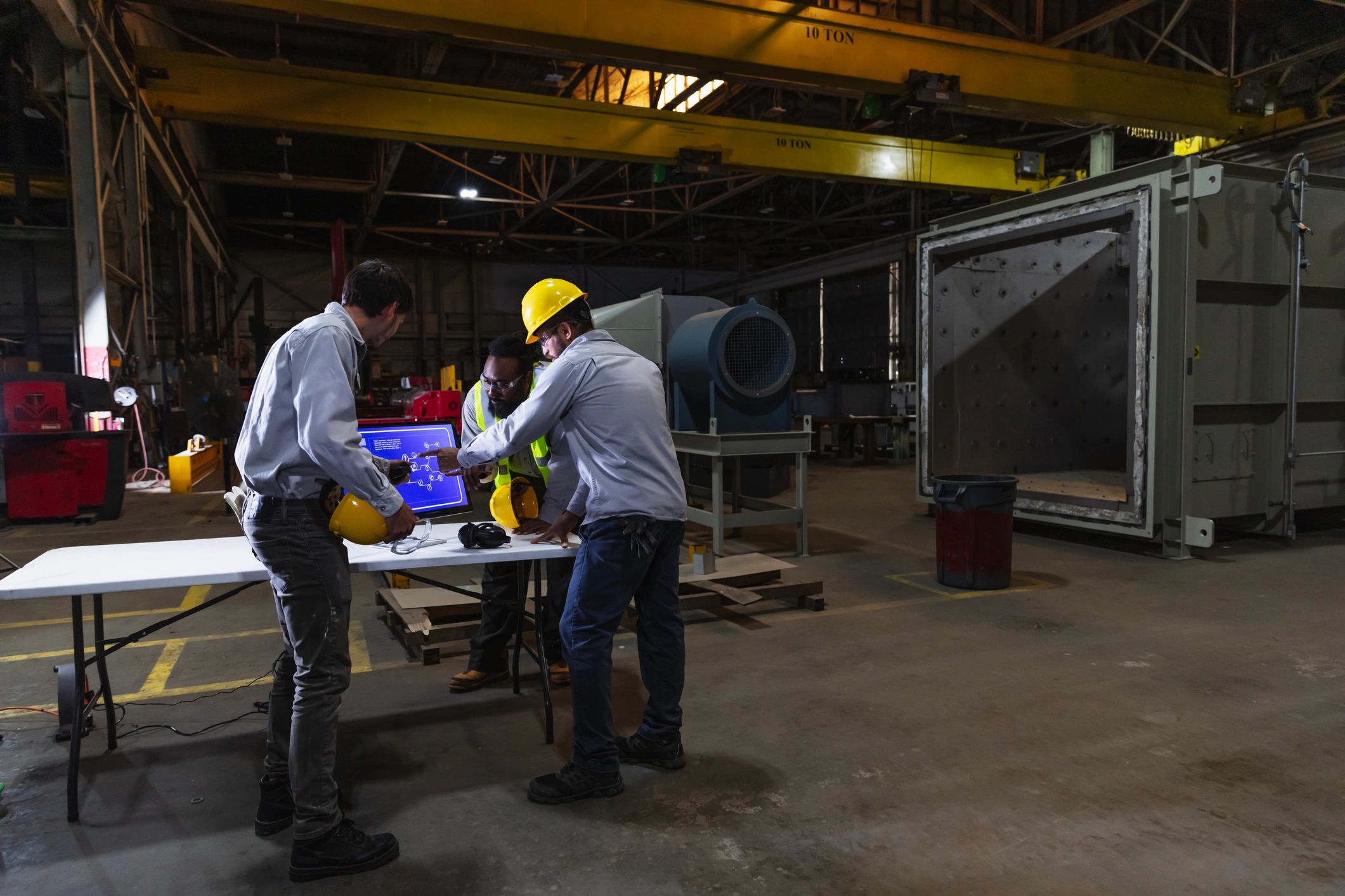 Team members reviewing production details in a factory setting